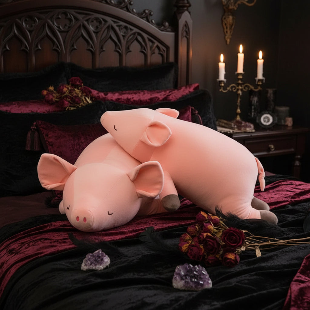 Two pink pig plush toys on a surface with a blurred indoor background