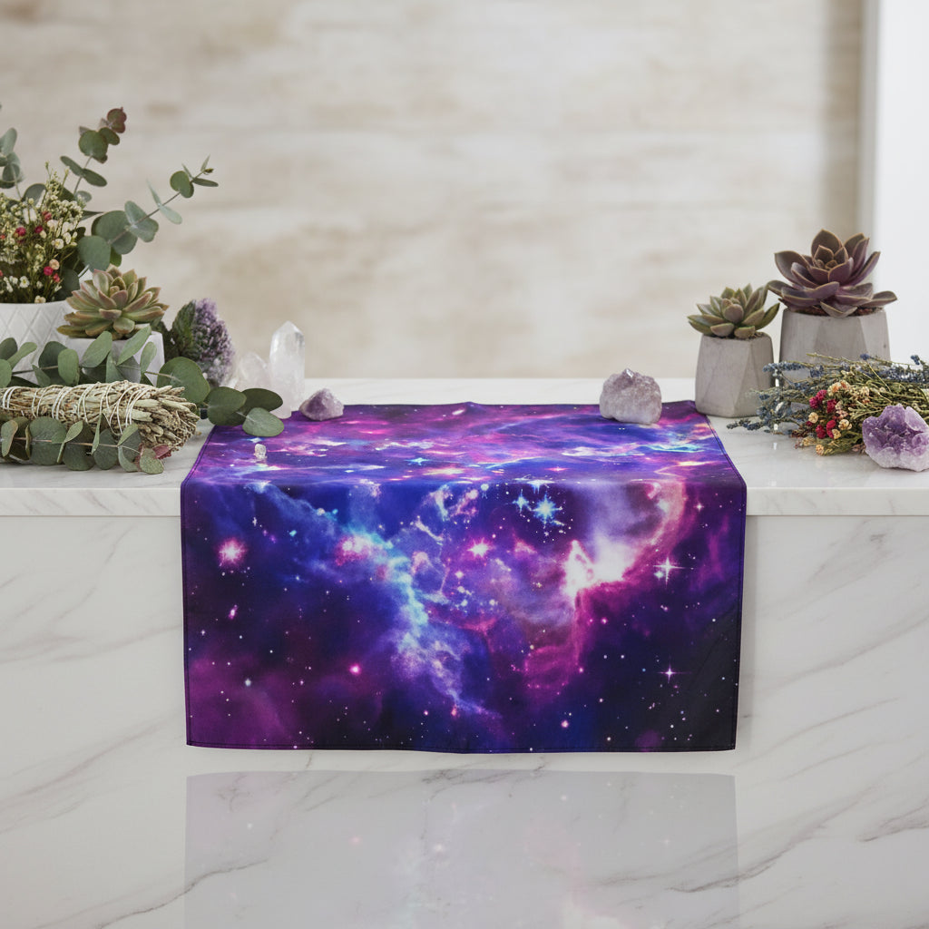 Galaxy tapestry hanging on a wall with a small table and decor items below.