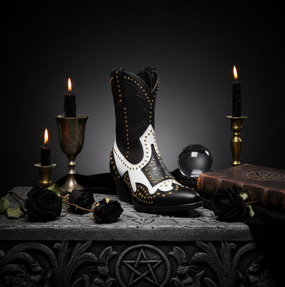 Black and white boots with gold studs on a white background