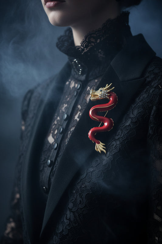 Red dragon brooch with gold crown on a white background