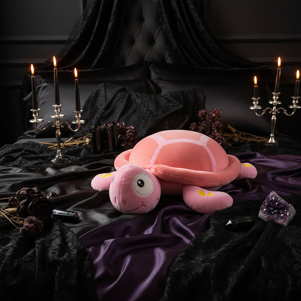 Pink plush turtle toy on a checkered tablecloth with a blurred indoor background