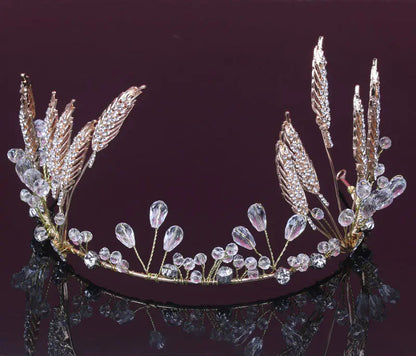 Elegant tiara with feather and crystal design on a dark background