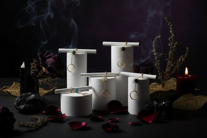 Gold rings with gemstones on a white stand