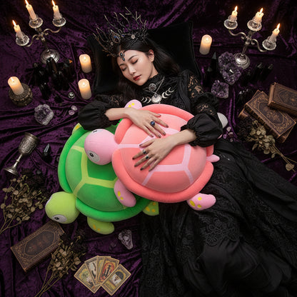 Person lying on a large turtle-shaped pillow with a soft toy.