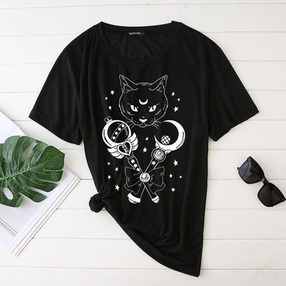 Black t-shirt with a cat and moon design on a white wooden surface