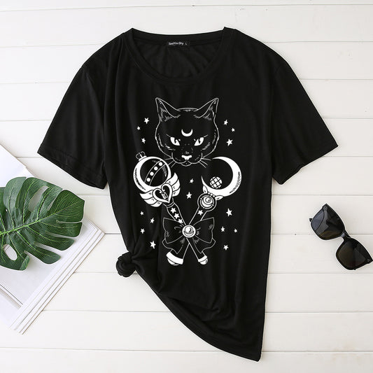 Black t-shirt with a cat and moon design on a white wooden surface