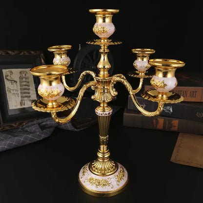 Gold candelabrum with marble base on a dark surface