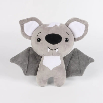 Plush toy bat with gray wings and white face on a light gray background