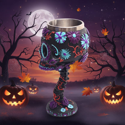 Decorative skull-shaped cup with floral designs on a white background
