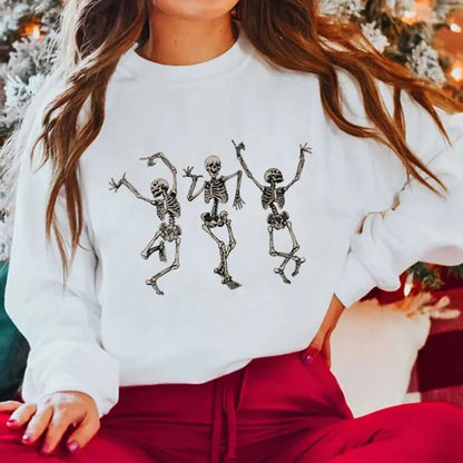Person wearing a white sweatshirt with skeleton designs in a festive setting