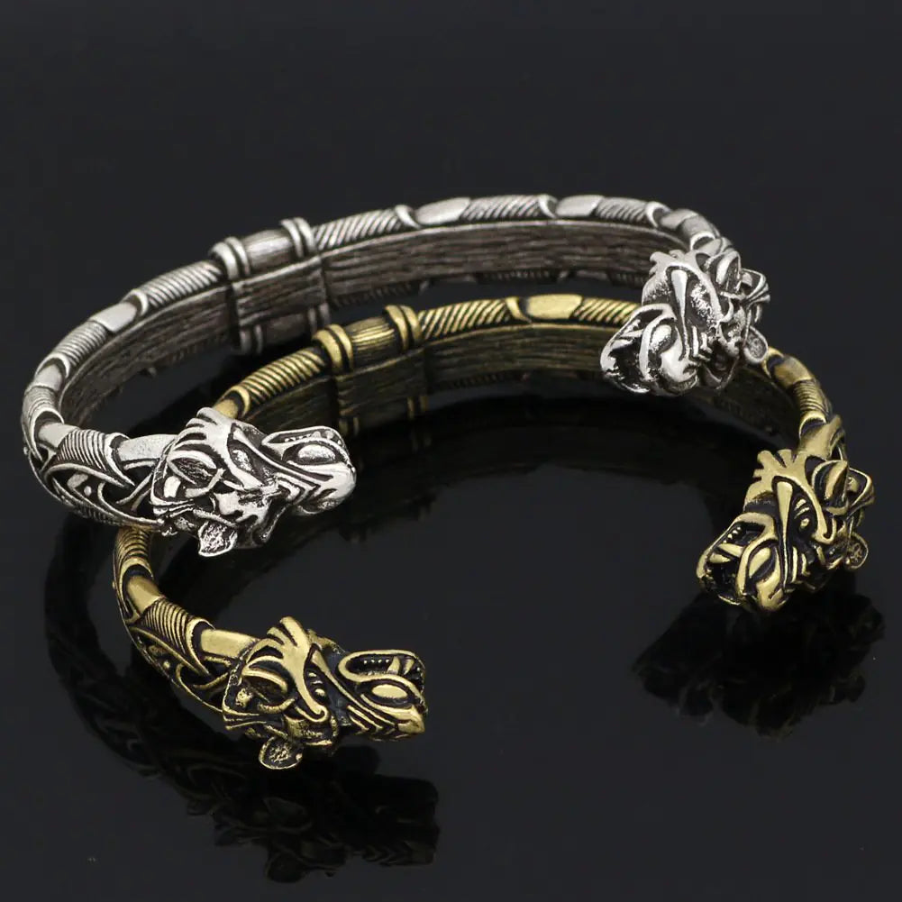 Bracelet with wolf head designs in silver and gold on a black background