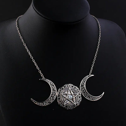 Necklace with triple moon pendant and pentacle design on a black mannequin.