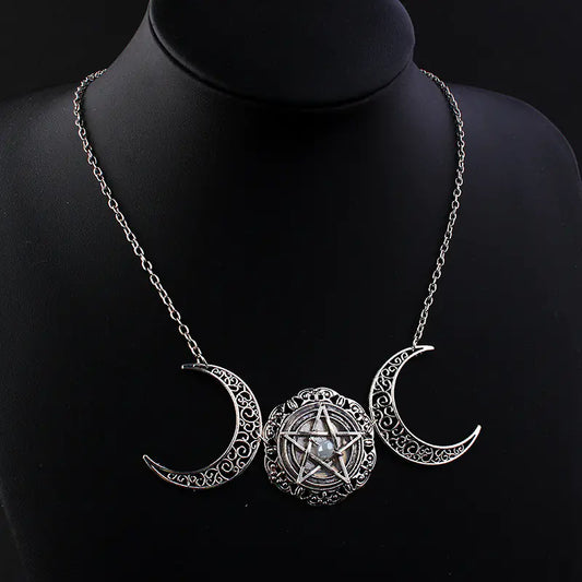 Necklace with triple moon pendant and pentacle design on a black mannequin.