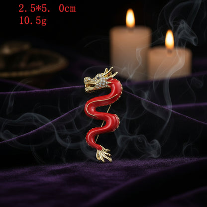 Red and gold dragon-shaped brooch on a white background with text