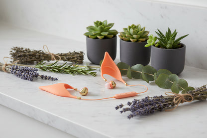 Orange wireless earbuds with a white background