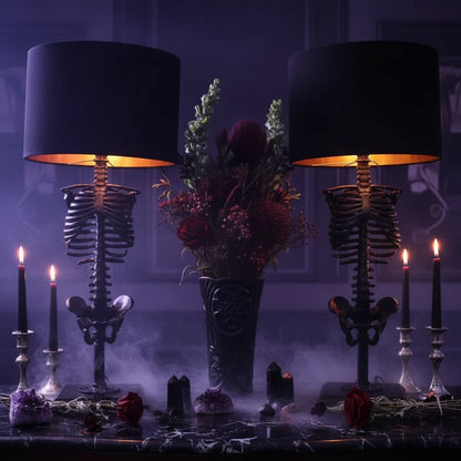 Two skeleton-themed lamps with black shades on a dark background