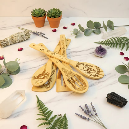 Set of wooden spoons with engraved designs on a light background