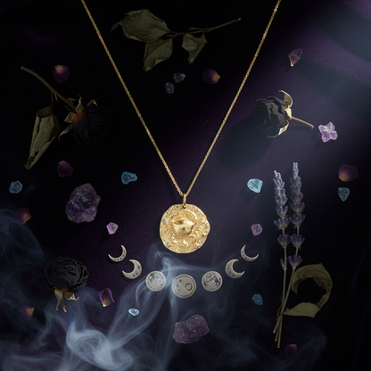 Gold necklace with a zodiac pendant on a white background