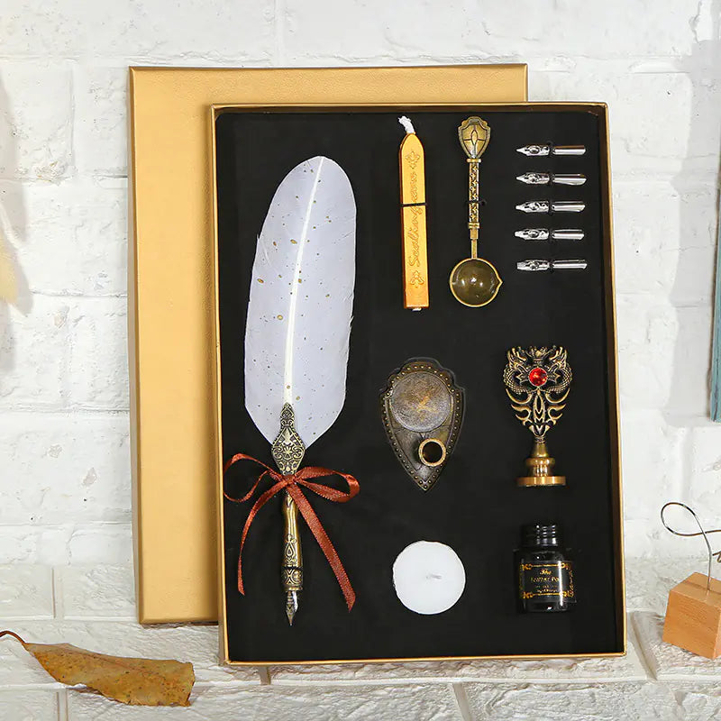 Decorative set with feather, candles, and decorative items in a black box on a white brick wall background.