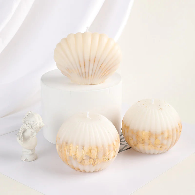 Decorative shells on a white surface with a small sculpture.
