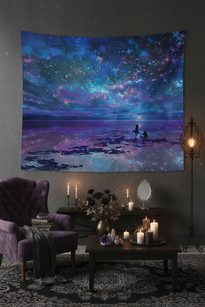 Tapestry with a cosmic scene of two people on a beach under a starry sky.