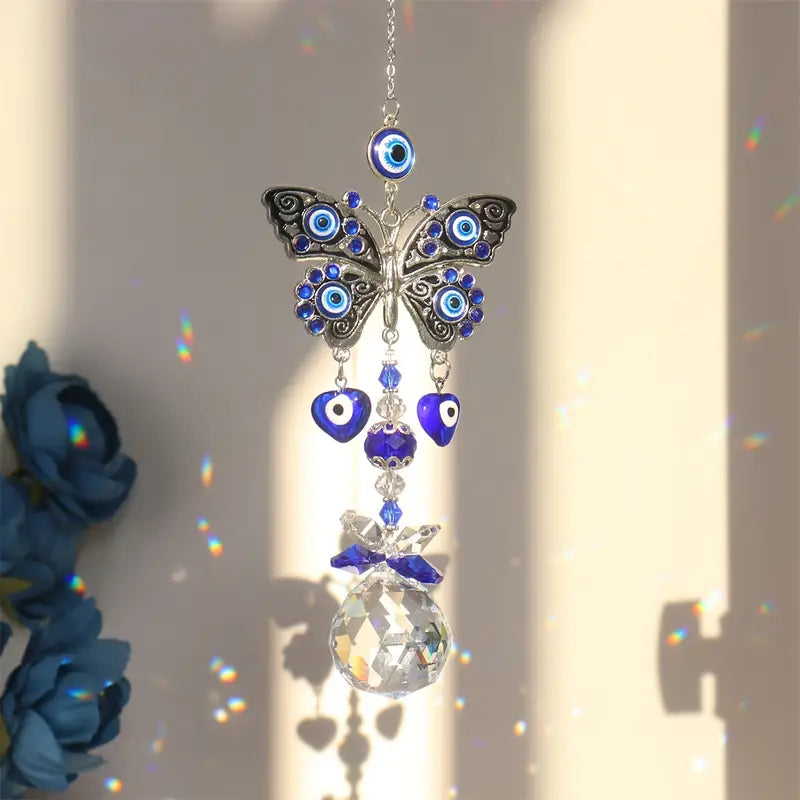 Butterfly-shaped ornament with blue eyes and crystal ball on a neutral background