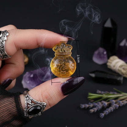 Yellow decorative item held between fingers with measurements, blurred background