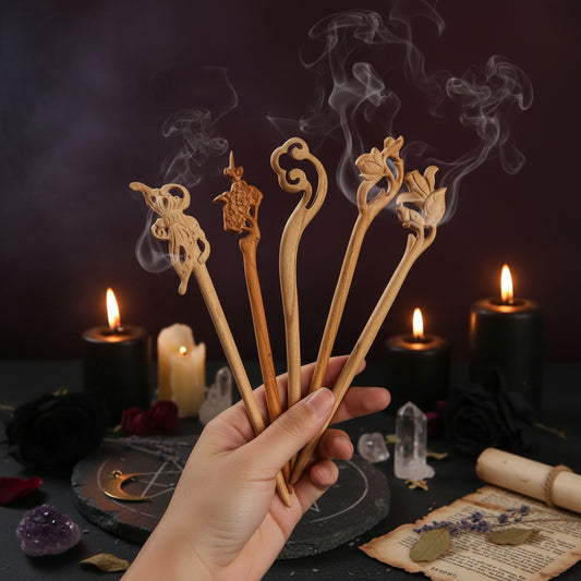 Set of decorative wooden sticks held against a black background