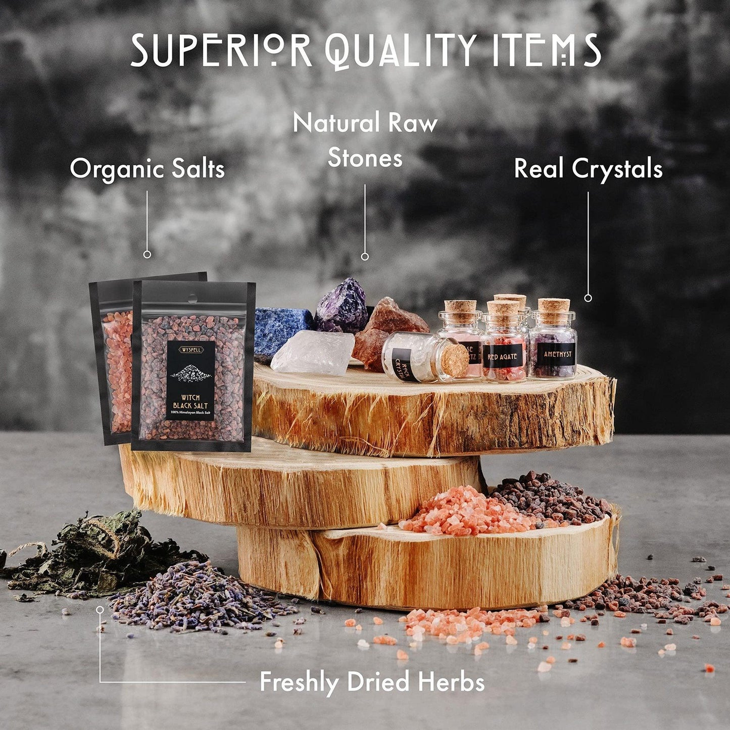 Wooden display with organic salts, natural raw stones, real crystals, and freshly dried herbs on a gray background.