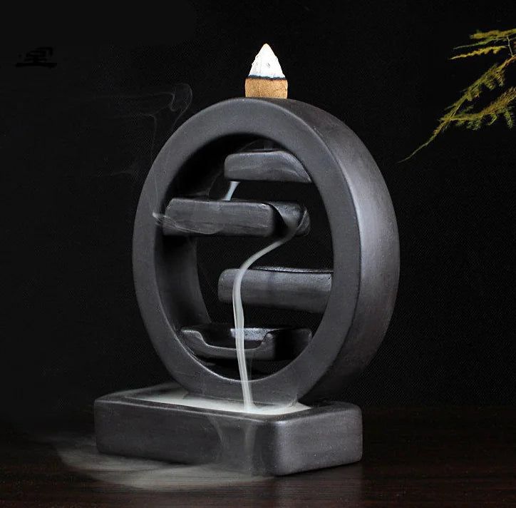 Cylindrical incense burner with smoke on a dark background