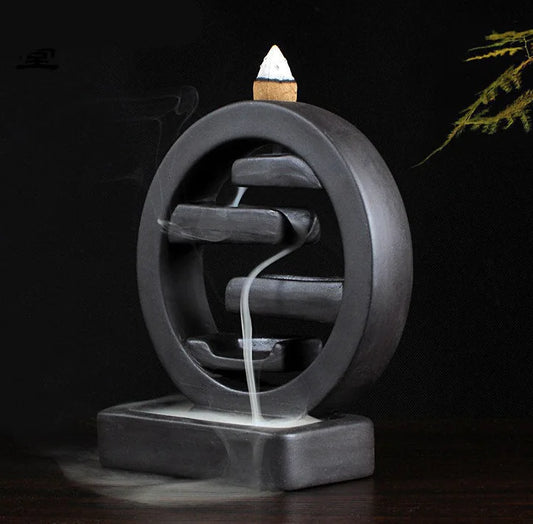 Cylindrical incense burner with smoke on a dark background