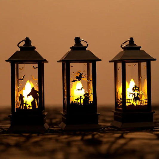 Three Halloween-themed lanterns with glowing interior scenes on a dark background.