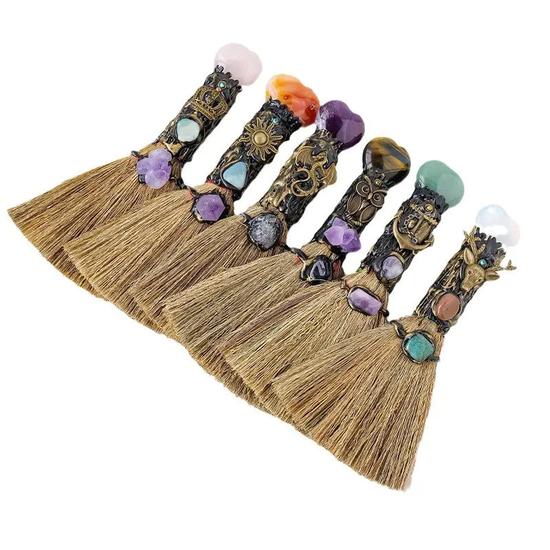 Set of decorative brooms with gemstone handles on a white background