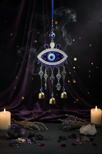 Decorative evil eye hanging with bells against a blue background