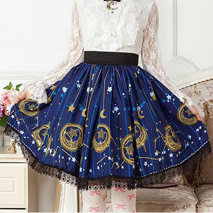 Person wearing a white lace top and blue skirt with star and moon patterns, sitting on a couch.