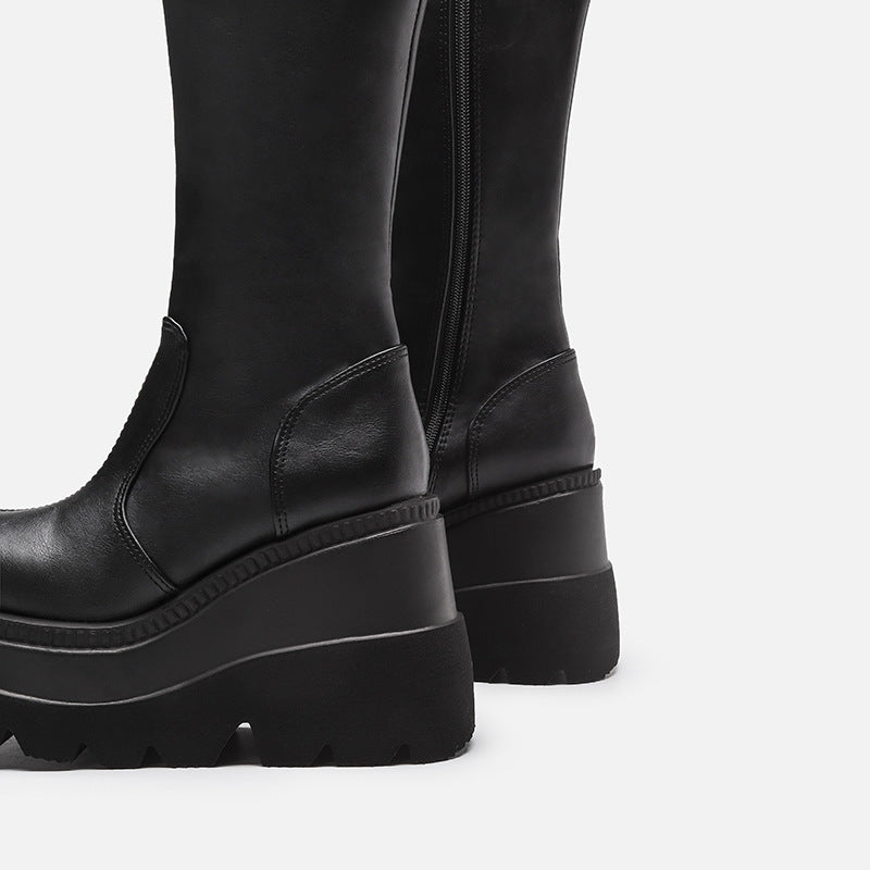 Black platform boots on a light gray background