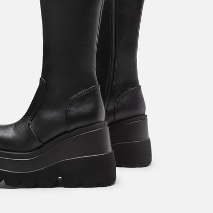 Black platform boots on a light gray background