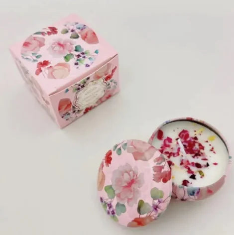 Floral-patterned candle in a decorative box on a light background