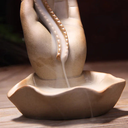 Ceramic incense burner with a natural stone finish on a wooden surface