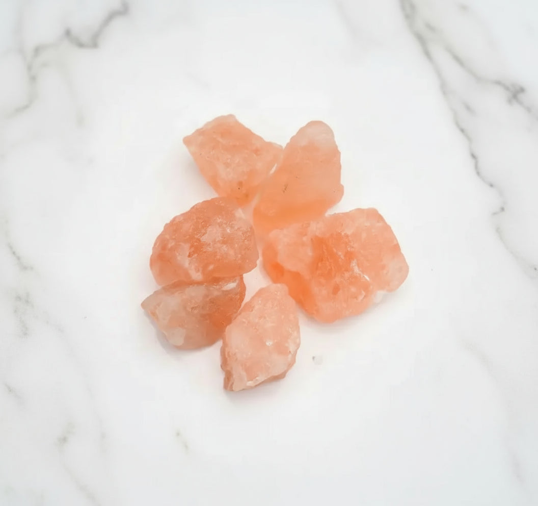 Raw pink crystal stones on a white background