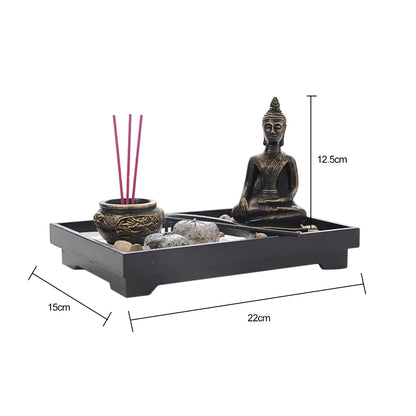 Decorative Zen garden with Buddha statue, incense, and stones on a white background