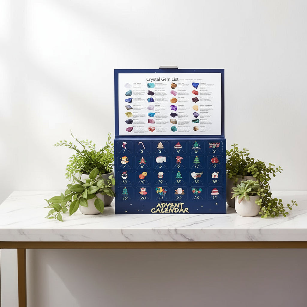 Advent calendar with crystal gems and a hand holding a green gemstone.