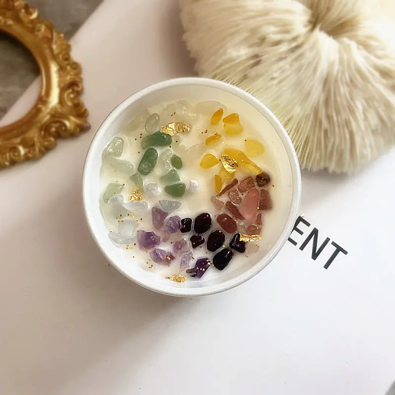 Small bowl with colorful stones on a white surface with 'SENT' text