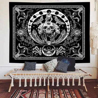 Decorative tapestry with a central skull design in a room with a bench and pillows.