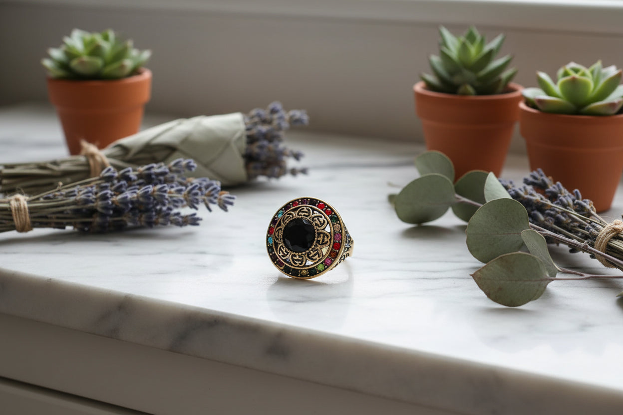 Decorative ring with black gemstone and multicolored stones on a black background