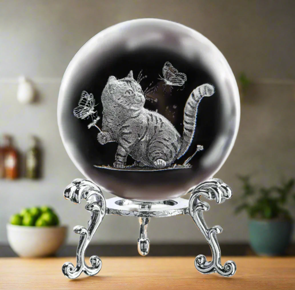 Decorative sphere with a cat and butterfly design on a white background