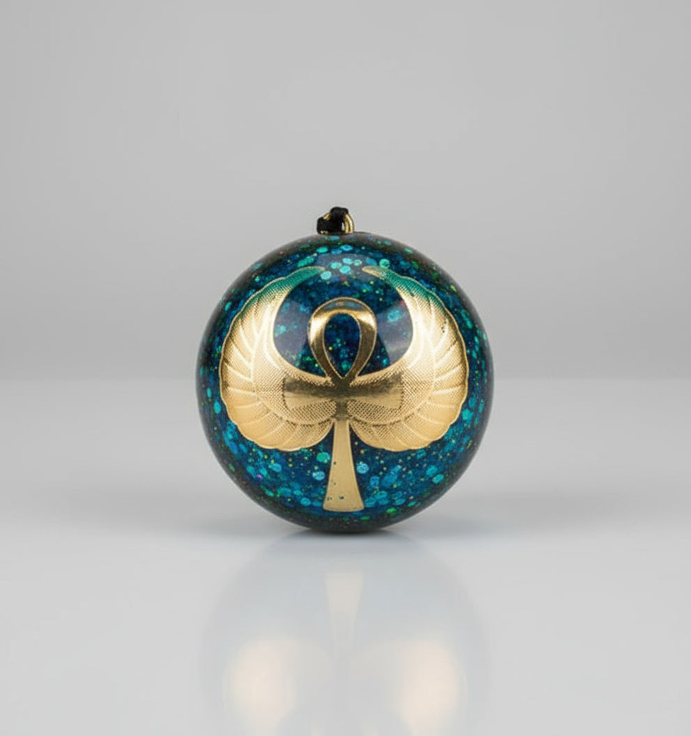 Decorative ornament with a cross and ribbon design on a glittery blue background