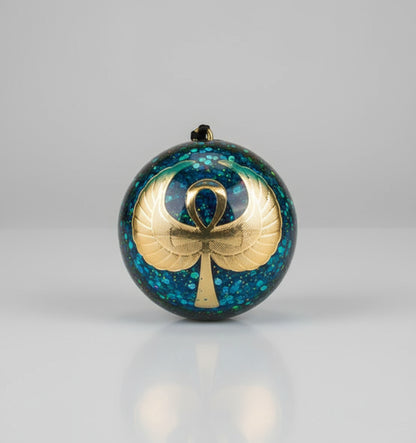 Decorative ornament with a cross and ribbon design on a glittery blue background