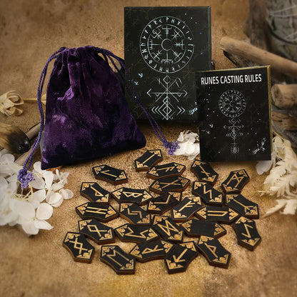 Set of runes with a purple drawstring bag and 'Runes Casting Rules' book on a textured surface.