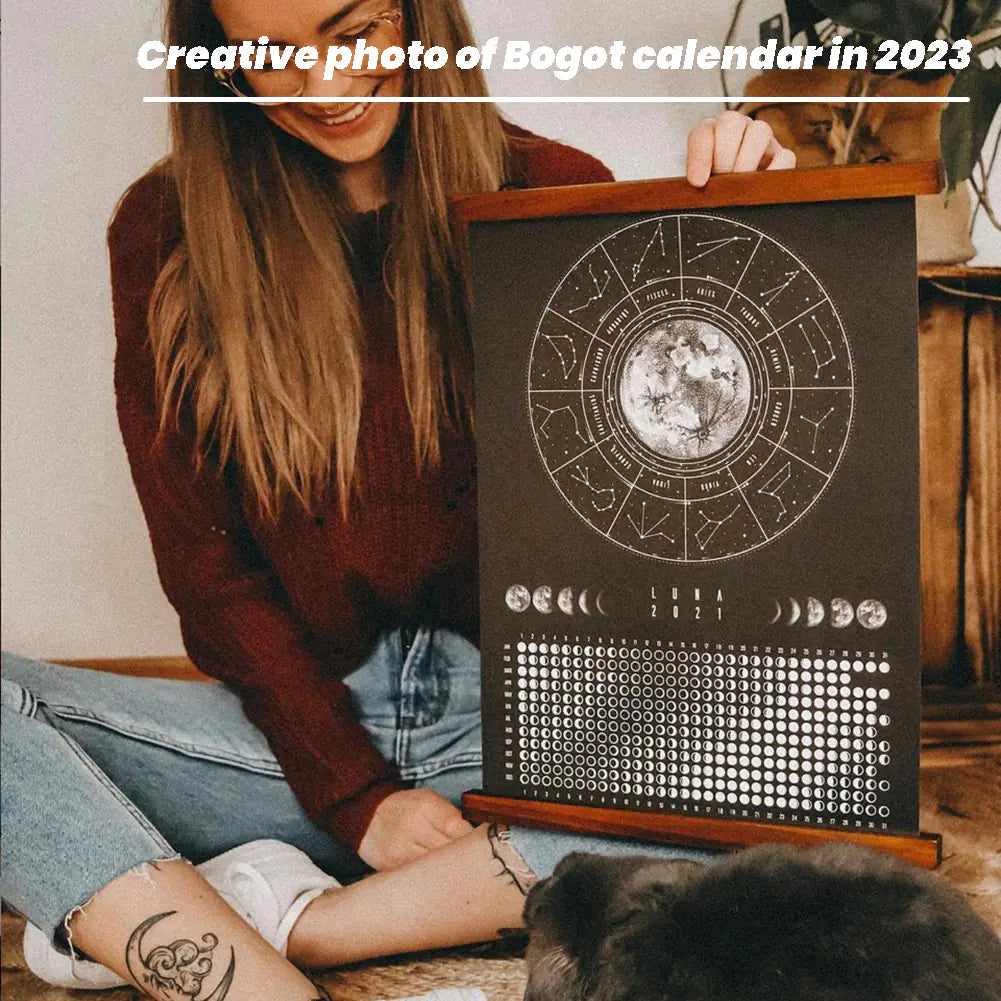 Person holding a calendar with astrological design, sitting on the floor with a dog.